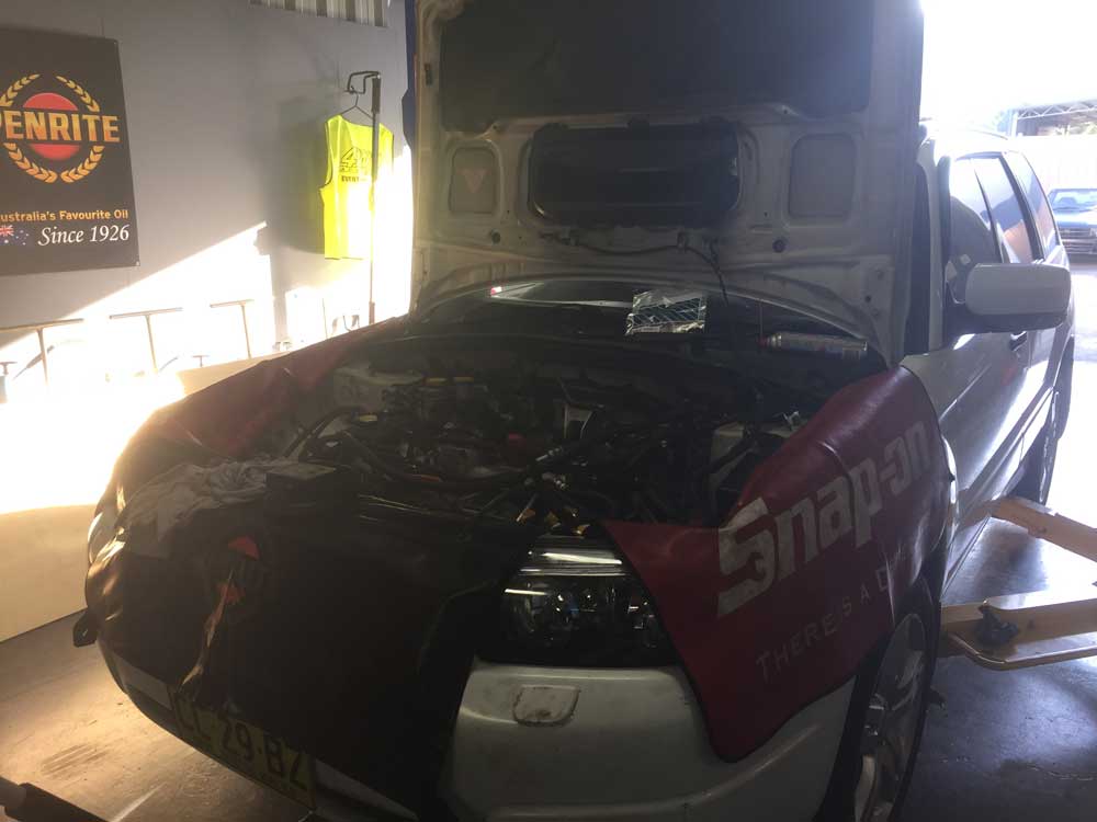 White Subaru open Hood — Mechanical Workshop in Bellambi, NSW